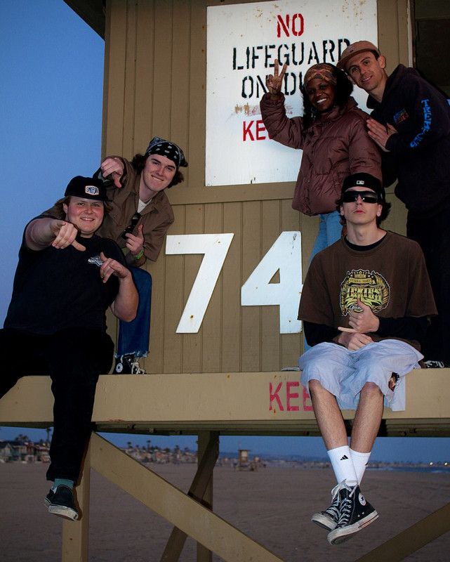 74ODD band members posed on the '74' lifeguard stand at twilight.