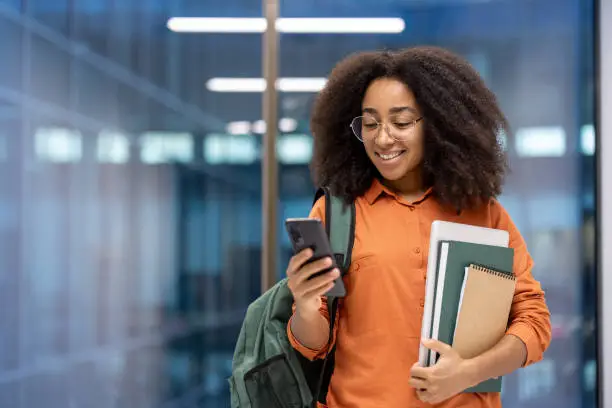 Student holding phone with EduWave app