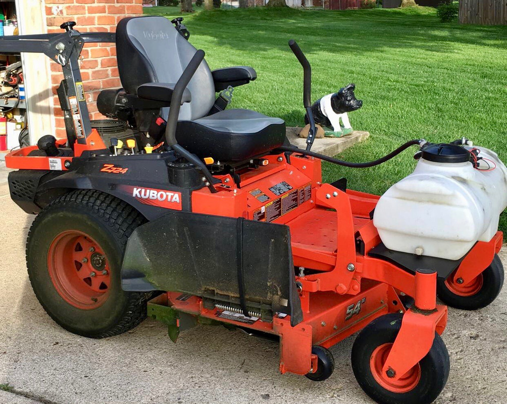 Image of Lawn mower with sprayer attachment for weed killer