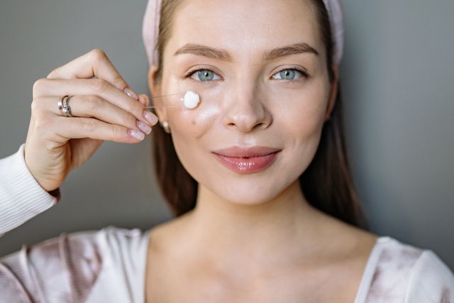 a woman applying glycerine containing moisturizer to support normal barrier function by maintaining skin hydration. 