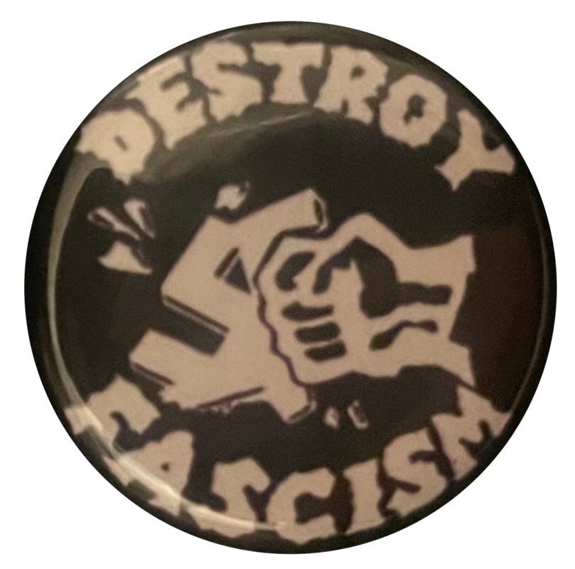 a black & white pin that says 'destroy fascism' with a fist punching a swastika in the center