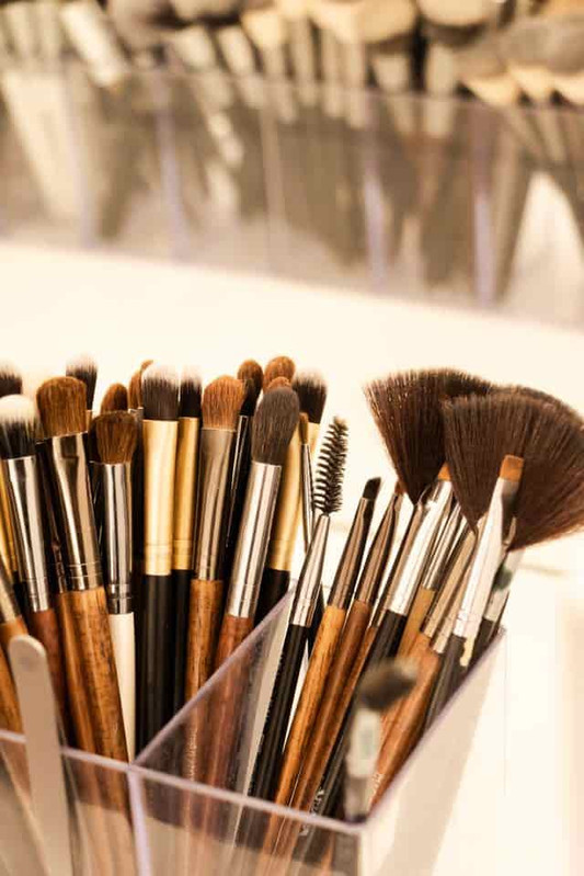 Used makeup brushes with visible cosmetic residue and buildup that can harbor microorganisms 