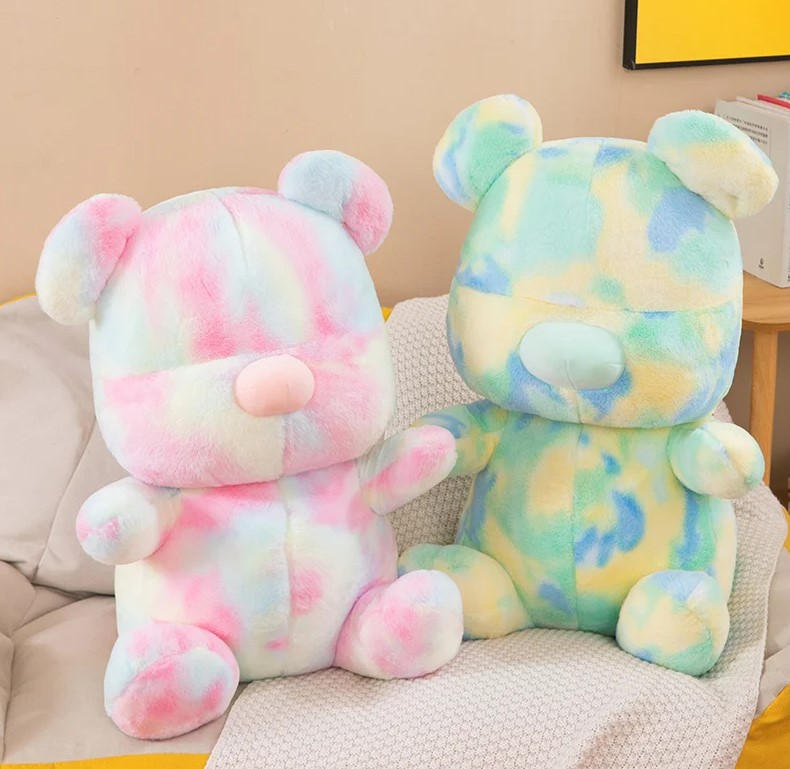 Two stuffed animals on a chair Description automatically generated