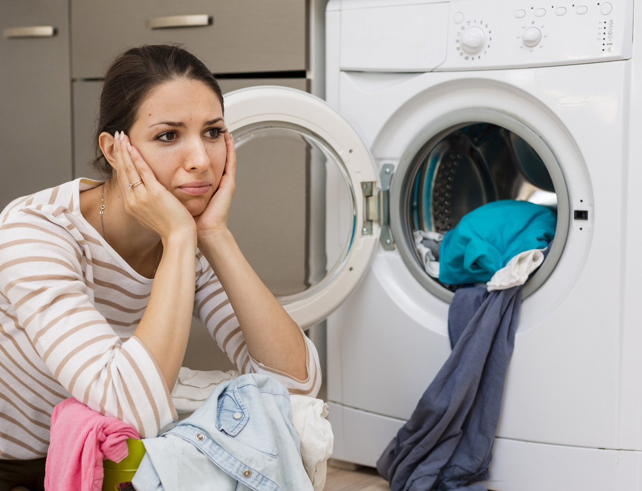 stressed woman doing laundry medium shot