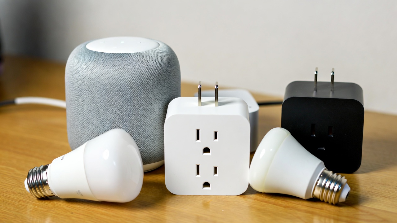 Collection of affordable smart home devices including a smart speaker, plug, and bulb on a wooden table