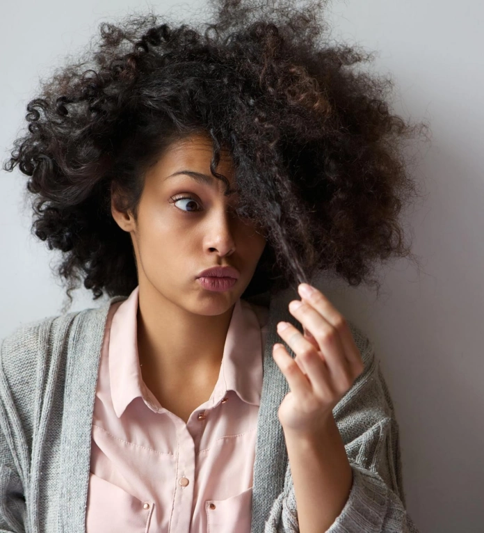 Long black curly hair with split-ends