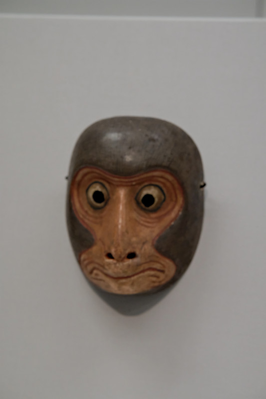 A Noh or Kyogen mask with a dramatic expression