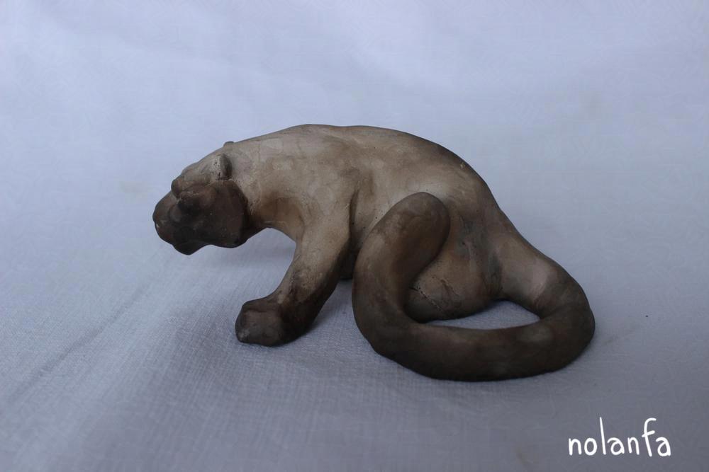 a clay panther with color in a gradient from dark to light