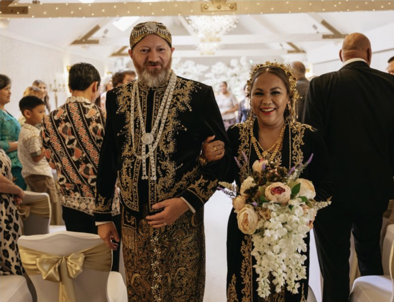 Herni and Graham in traditional wedding attire