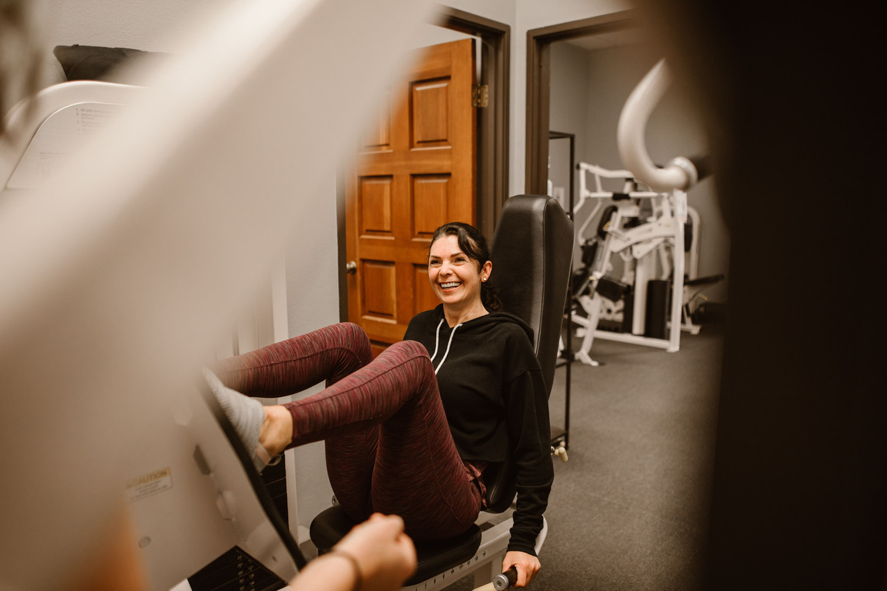Adult holding a barbell during a structured resistance training session to protect lean muscle while on GLP-1 medication