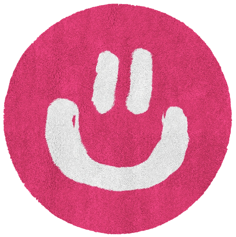 A round pink rug with a smiley face on it.