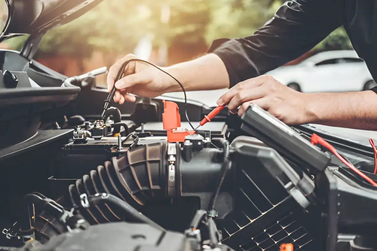 Car emergency kit with jumper cables, first aid, and safety triangle