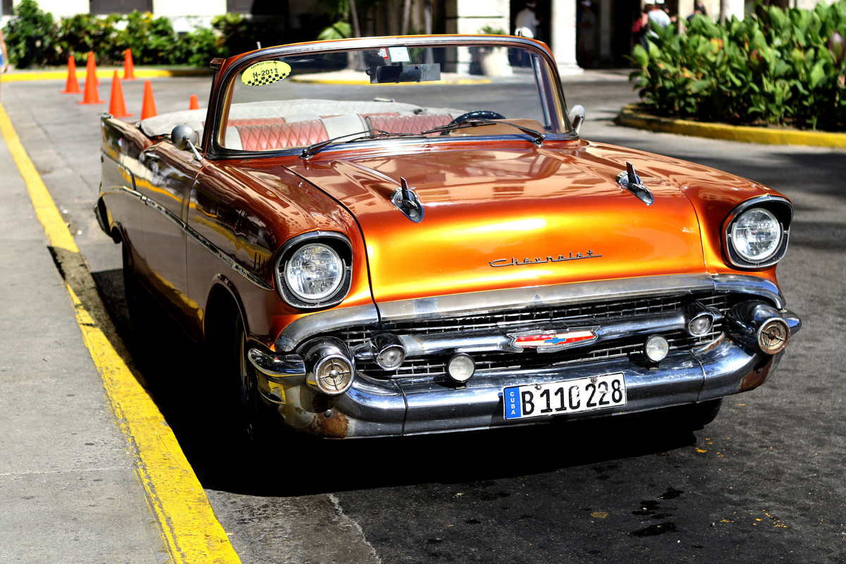 Orange-Convertible-Parked-Near-Leafed-Plants.jpg