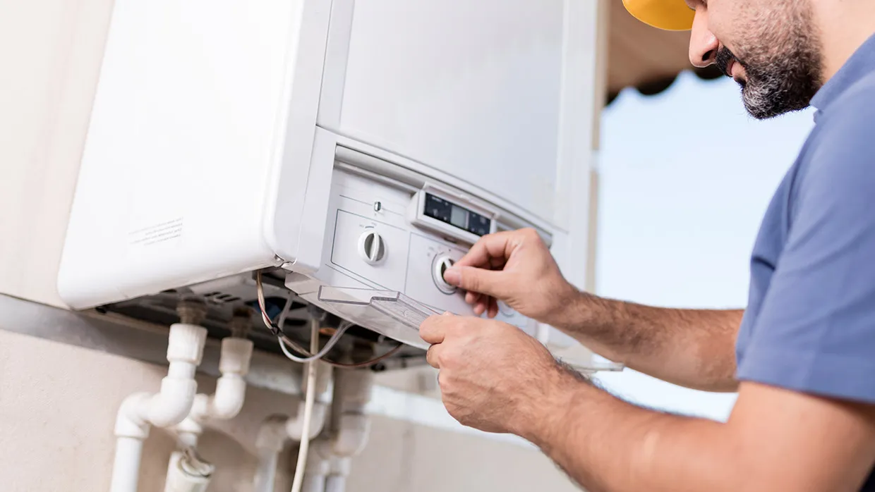 Tankless water heater repair Albuquerque certified plumber inspecting unit
