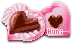 A pink heart-shaped box filled with heart-shaped chocolate.