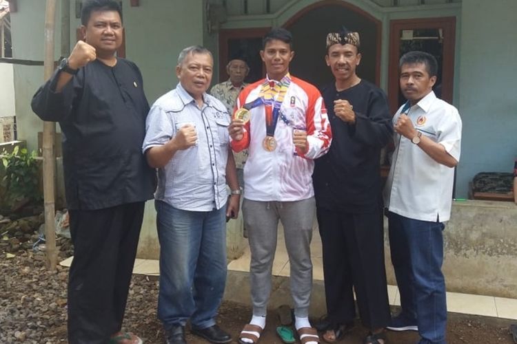 Muahammad Taufik (32) atlet asal Kabupaten Tasikmalaya yang meraih medali emas di Sea Games Filiphina bersama Koni dan pejabat daerah setempat di rumahnya, Selasa (10/12/2019).