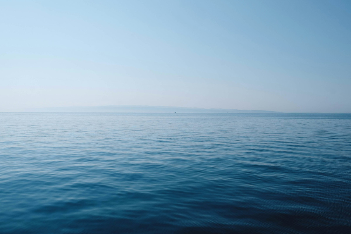 A beautiful, high-quality photo of a calm ocean, representing clarity and peace.