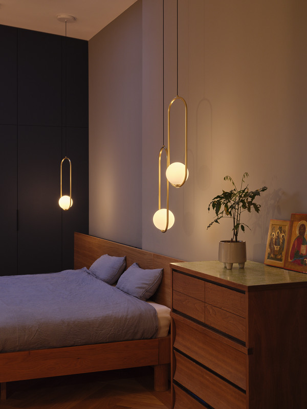 Bedroom with warm pendant lighting