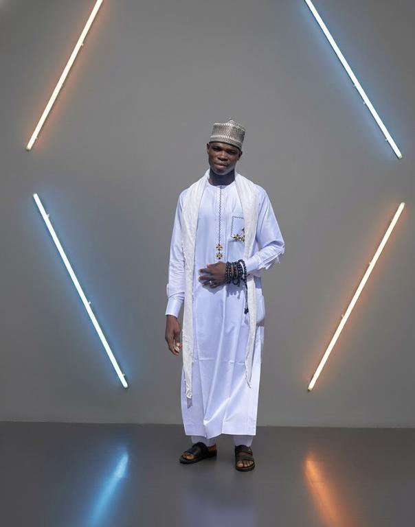 Elaborate white embroidered kaftan with detailed patterns by FAWLUX bespoke tailors Nigeria