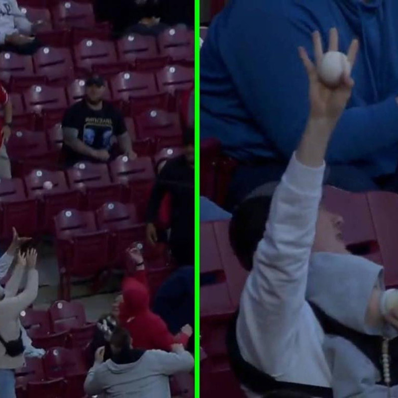 En MLB papá sorprende al detener una pelota mientras da biberón a su bebé