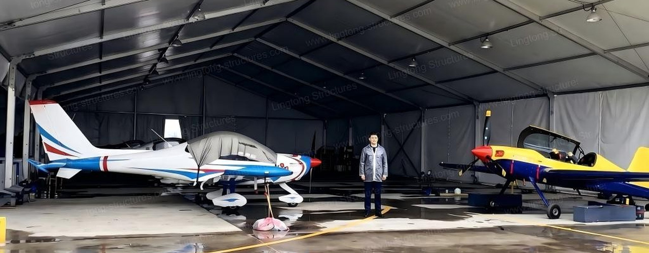 Large span aluminum aircraft hangar tent with clear span interior and modular aluminum frame for versatile aircraft storage and maintenance