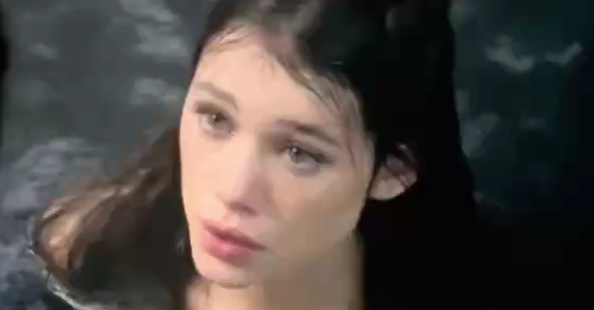 sexy girl is sitting in the water and showing her boobs.