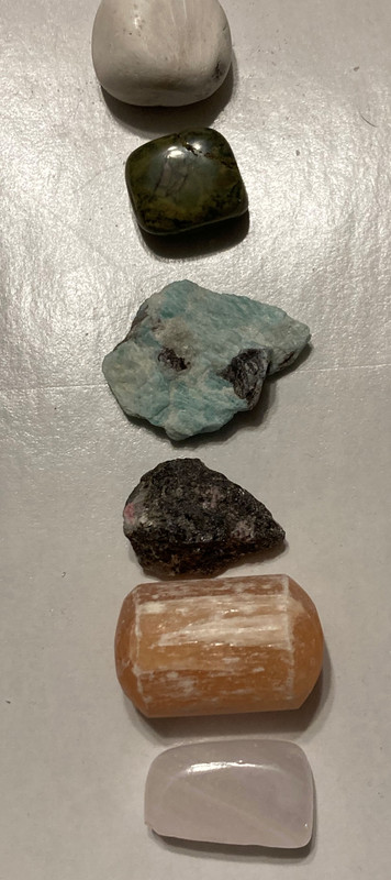 scolecite, rhyolite, rhodonite, tumbled orange selenite, raw amazonite, tumbled pink calcite, mystery gift, 15ml juniper berry water, information sheet