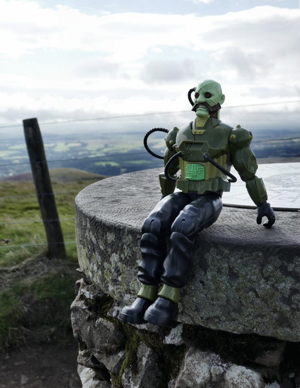 Green Robot climbing the stone marker post at Allermuir Hil. B5-D63-EFC-320-F-4-A6-C-B99-C-21-EA8-C7-E0-FD7