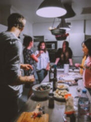 friends having dinner in kitchen