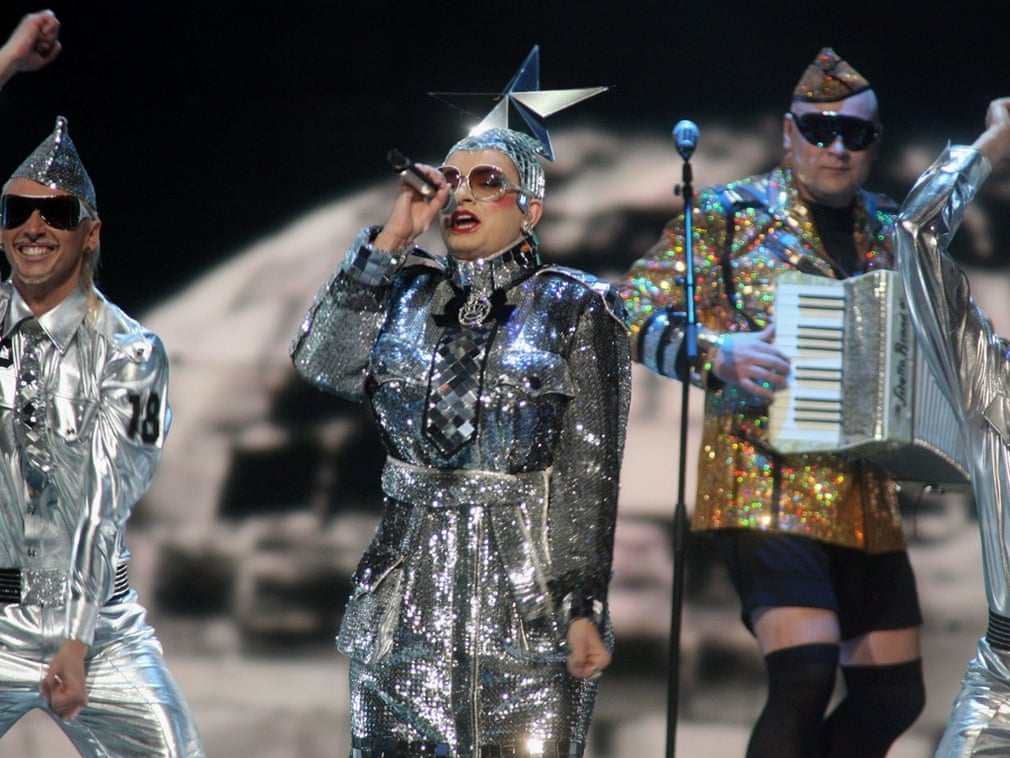 A band dressed in silver performing