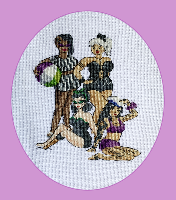 Embroidered artwork of the Inked Ladies on the beach. Ivan is wearing a striped two-piece swimsuit and holding a beach ball. Fang is standing next to her, with a white ponytail and a black swimsuit with studs and chains. Izzy is seated, wearing a black, strapless swimsuit and cat-eye glasses with green lenses. Her left leg is prosthetic. Ed is kneeling next to her in a purple bikini, many tattoos visible, wearing a white sailor cap and holding her hand over her eyes. She looks intrigued. 