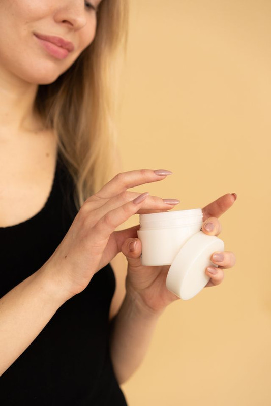 a woman applying occulusive ingredients on her skin to make her skin more healthy and resilient 