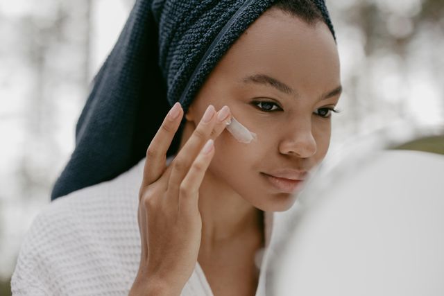 a woman using sunscreen as a last step of easy skincare routine for beginners