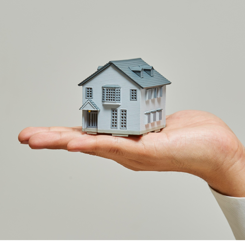 A small house held in an open palm