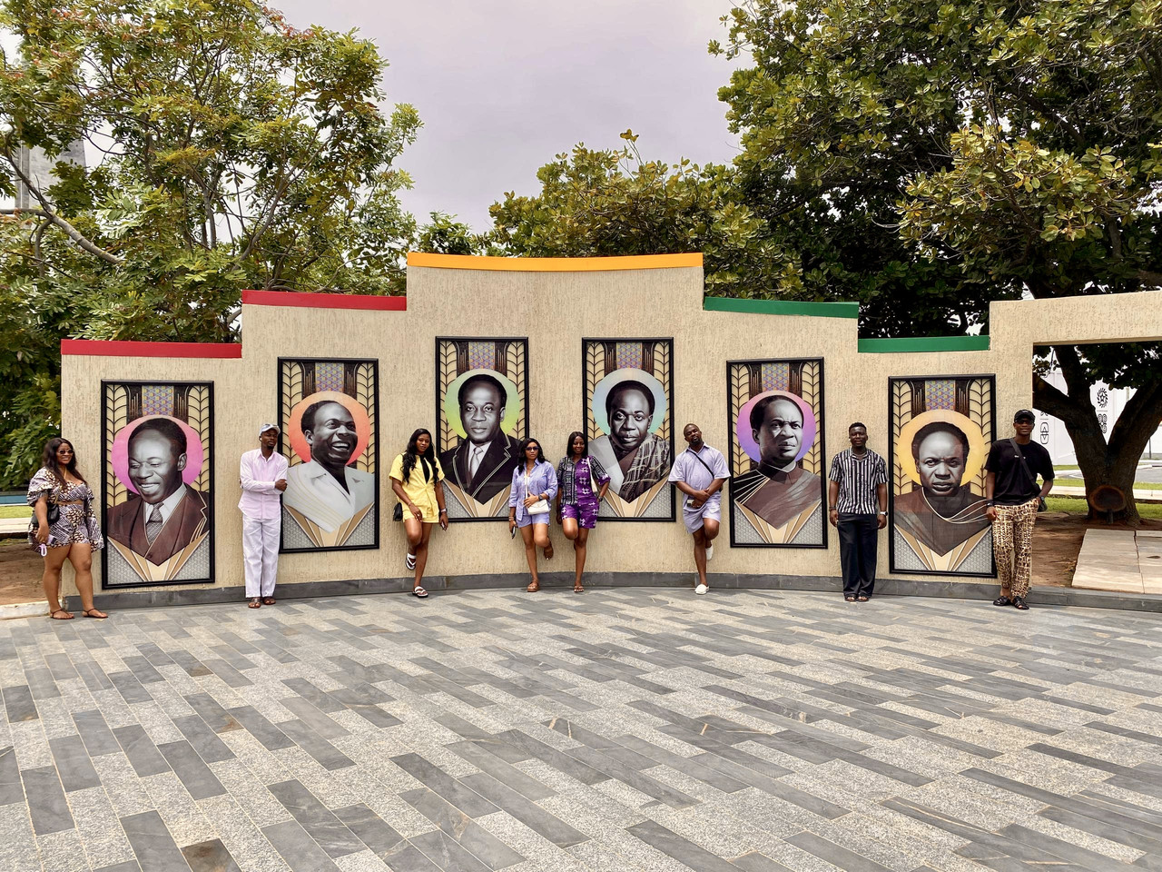 The Travloop group posing before the Kwame Nkrumah portrait mural at the memorial park in Accra
