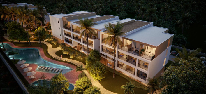 Perspectiva noturna da fachada iluminada do Auguri Praia