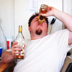 Man drinking from two bottles