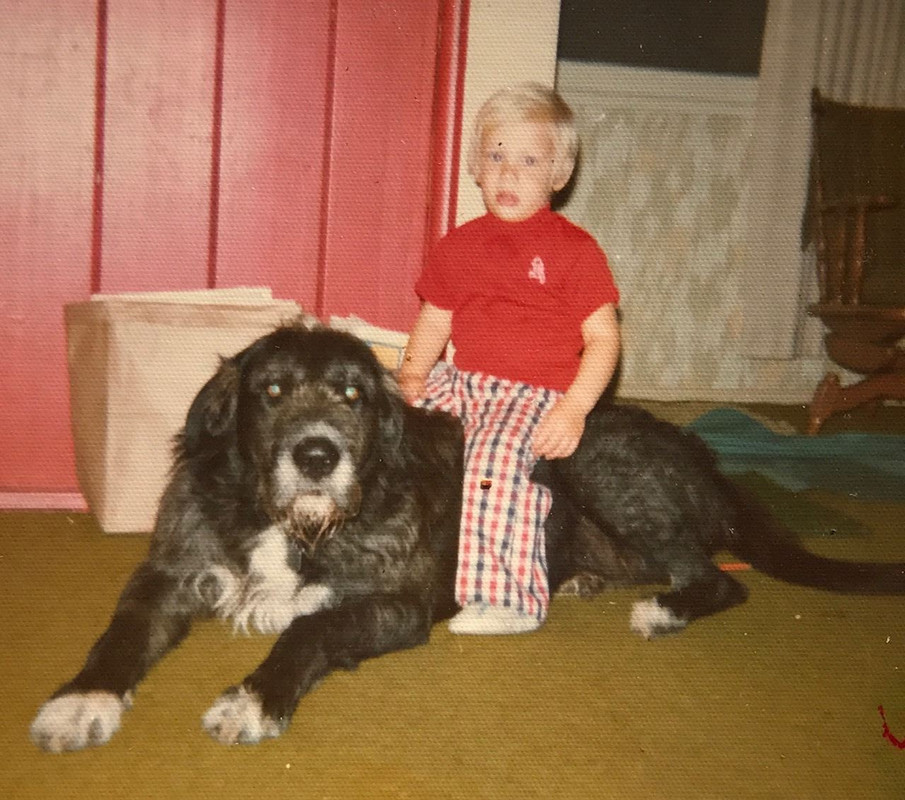 Zoltan Istvan in his childhood playing with a pet dog