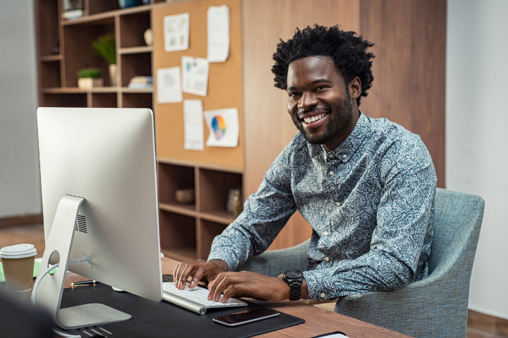 Two women coworkers smiling in warm toned office
