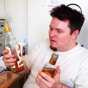 Man holding two bottles of alcohol