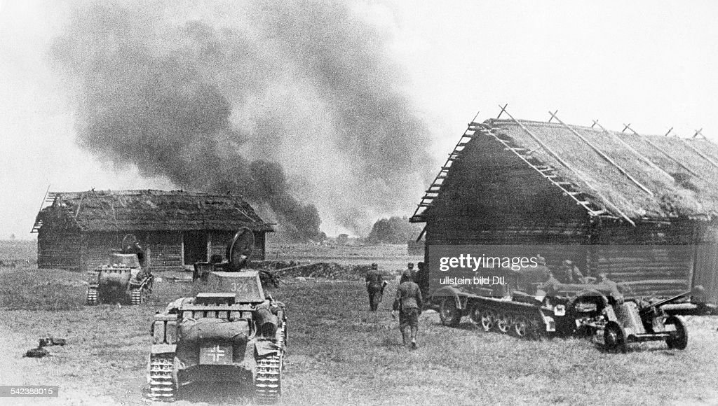 German units moving against burning cottages.left two tank 38(t) , right anit-tank-gun.End of July 1