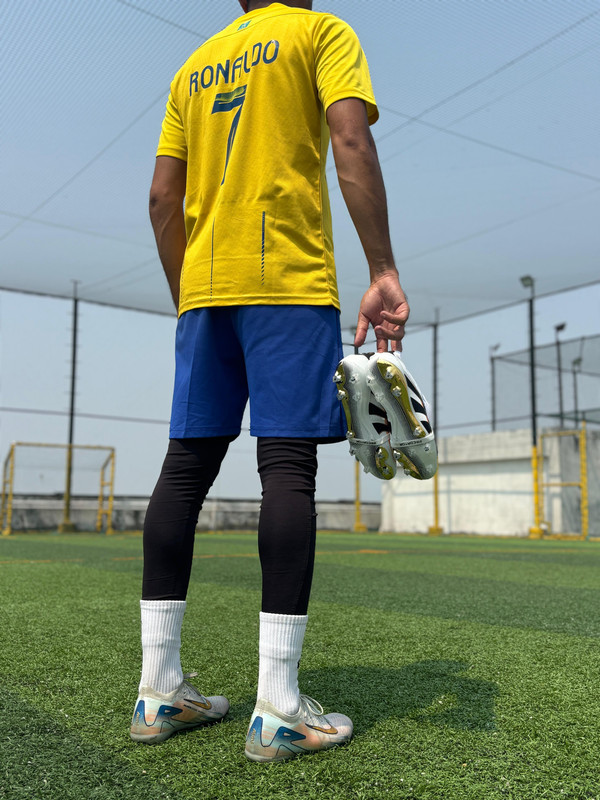 A person in sportswear tying their shoelaces, representing a sporty lifestyle.