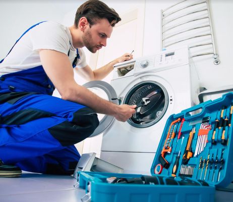Refrigerator repair technician at work