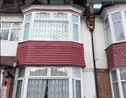 Exterior renovation after - bay window fully re-tiled in dark red tiles with clean finish