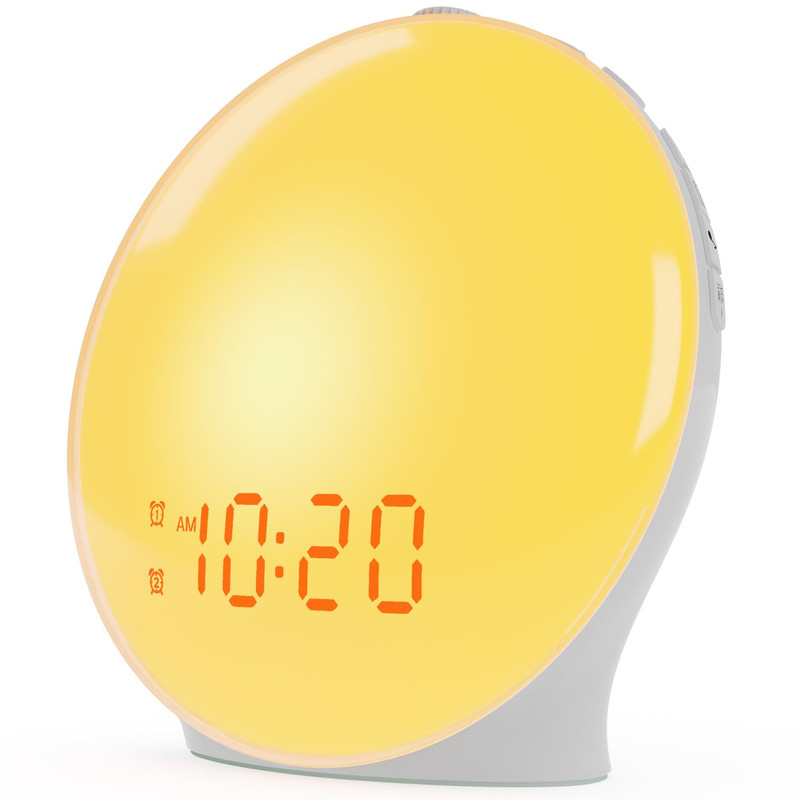 Sunrise alarm clock glowing on a bedside table