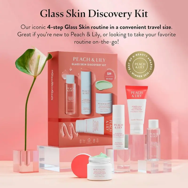 Peach & Lily Glass Skin Discovery Kit displayed with cleanser, essence, serum, and cream in soft peach tones