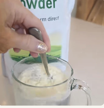 Customer mixing goat milk powder into coffee