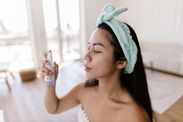 a woman using spray toner of glycerin and rose water on her face 
