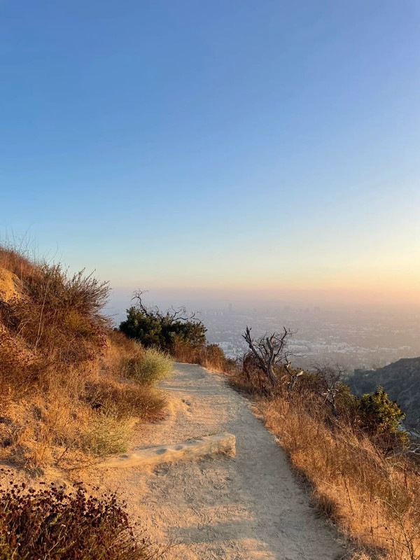 A dirt trail through hills, overlooking Los Angeles