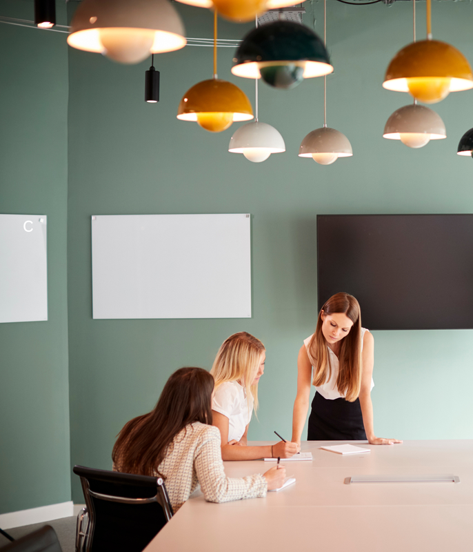 Group of coworkers in conference room warm tones